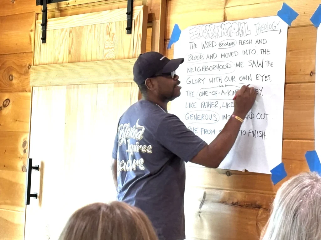 person leading a group gathering writing on a white paper